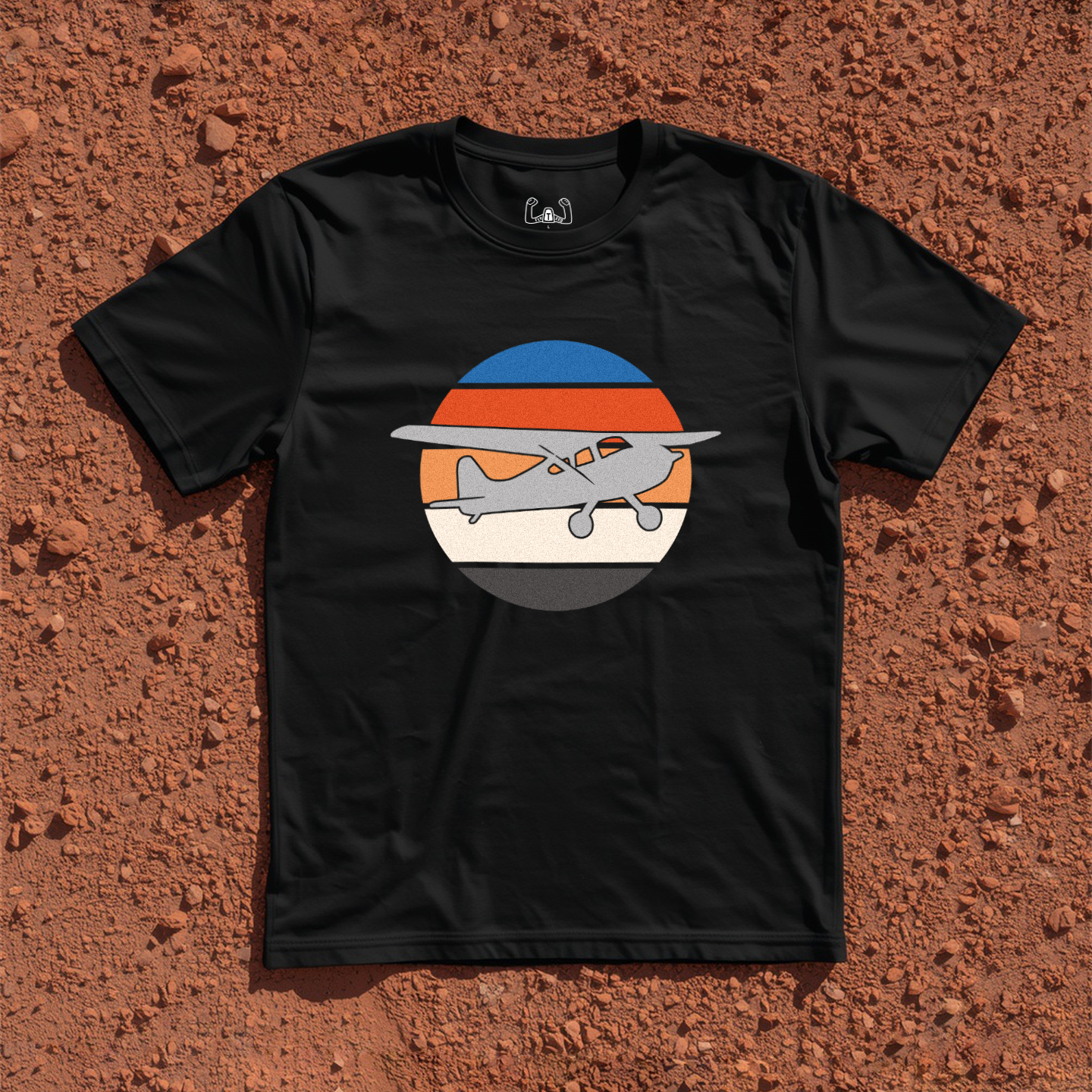 Silhouette Of A Bush Plane Flying Up to The Right Through Retro Sunset Tee